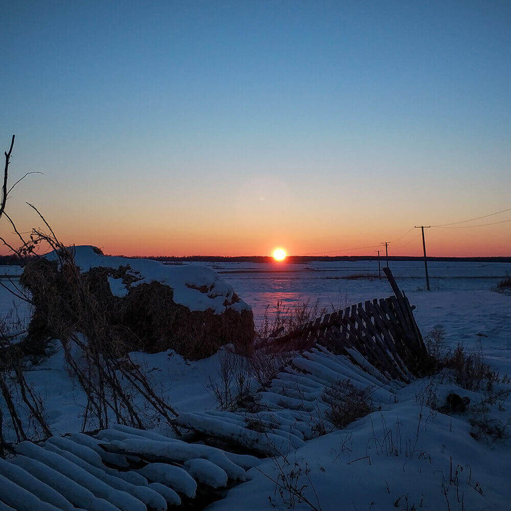 The setting sun almost seems to kiss the snow in Donglongshan Village.